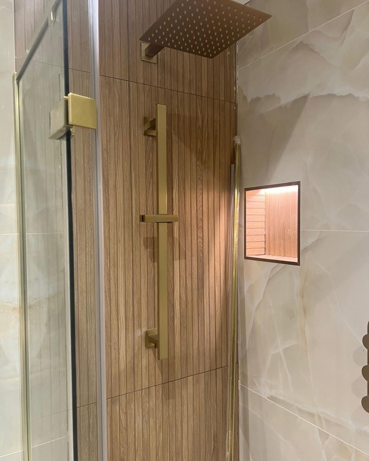 Walk-in shower with gold rainfall head