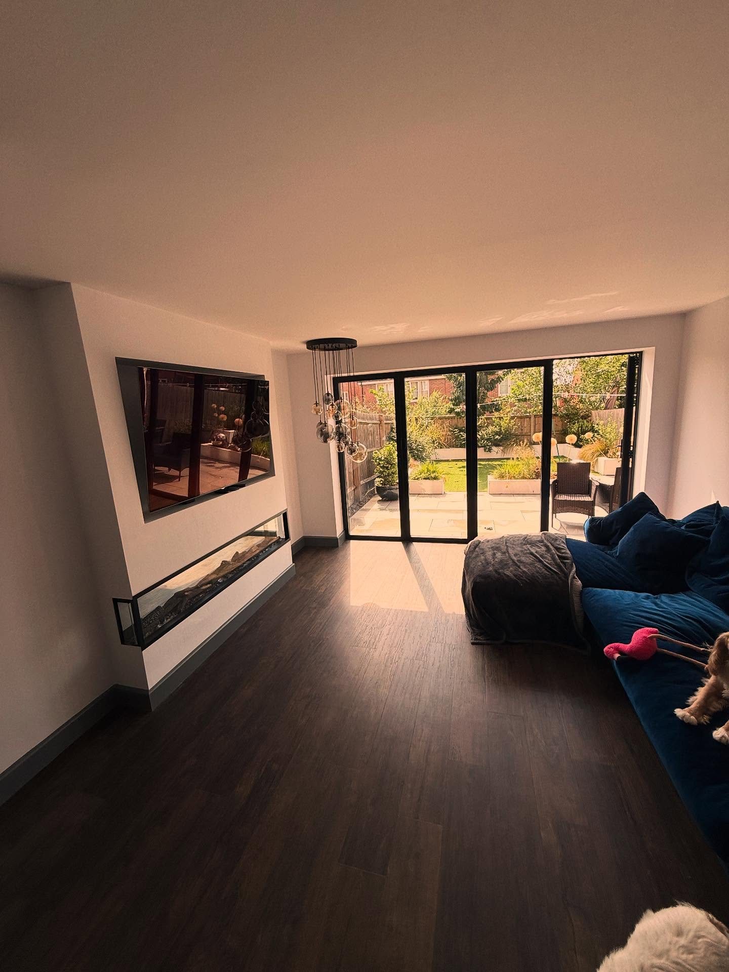 Finished extension living space with media wall and bifolds