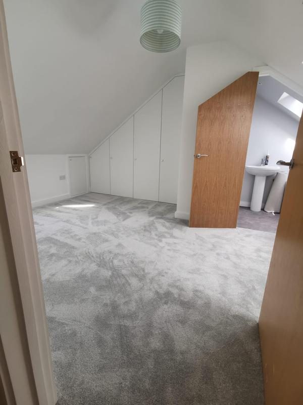 Finished loft bedroom with fitted eaves wardrobes