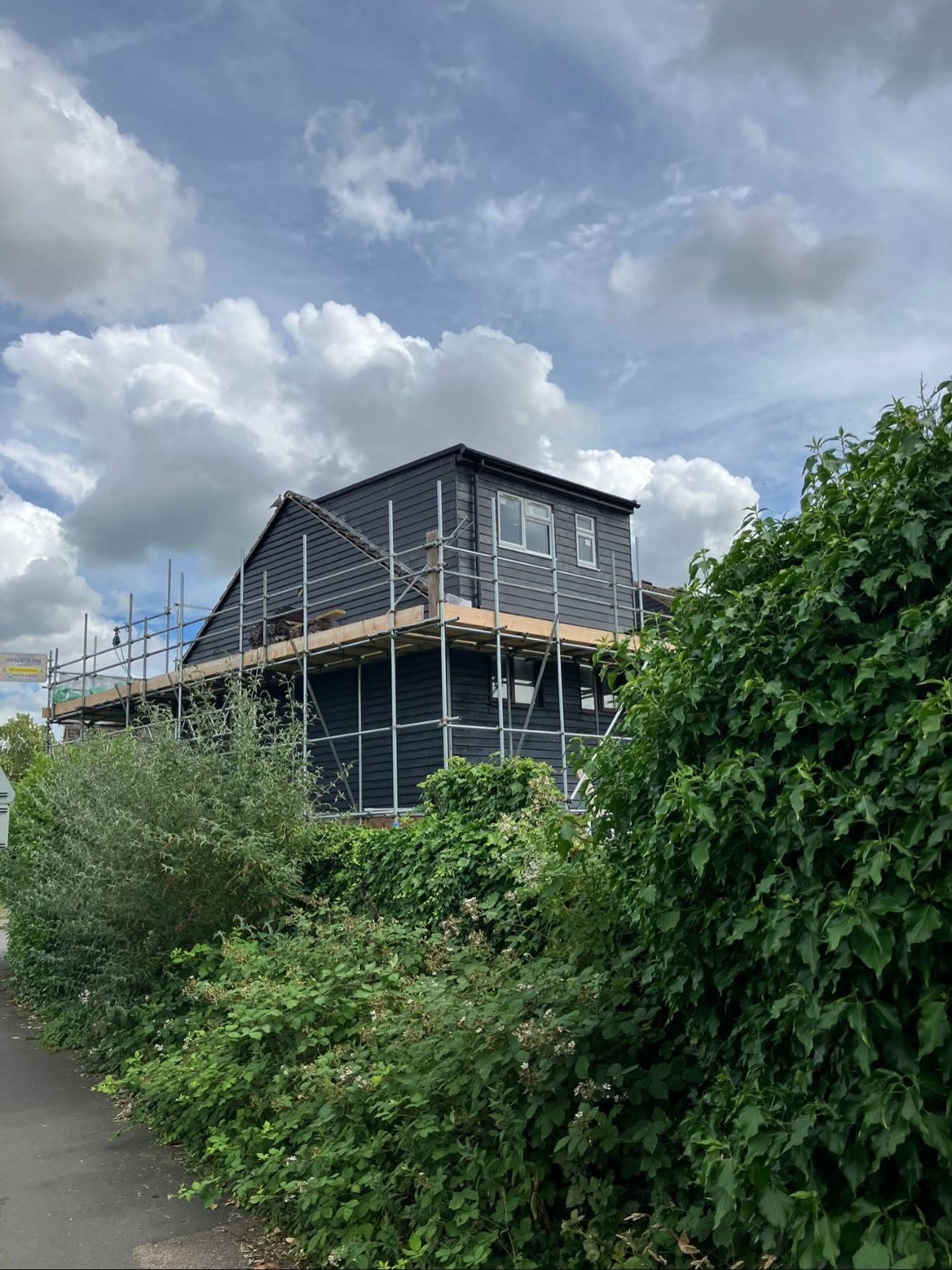Weatherboard clad loft conversion with scaffolding